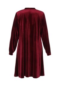 Burgundy bársonydressz hosszú puffos ujjakkal, kerek nyakkivágással és laza szabással, sima, puha textúrával és térd feletti hosszúsággal.