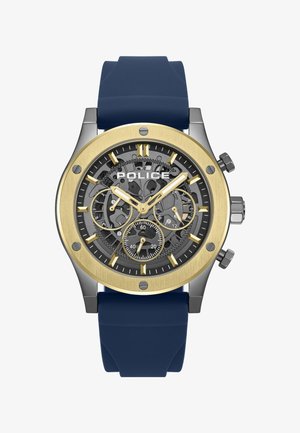 Orologio da uomo con cinturino in silicone blu navy, cassa metallica in oro e argento, quadrante scheletrato nero e indici delle ore dorati. Include subquadranti cronografici.
