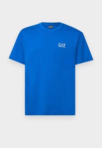 Blue cotton t-shirt with a crew neck and short sleeves. Features a small white EA7 logo on the left chest area. Smooth texture.