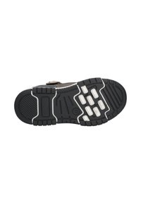 Black rubber shoe sole with textured surface, white accents, and various grip patterns. Features a rounded toe and reinforced heel area.