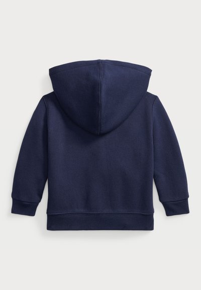 Sudadera azul marino con una textura suave, capucha redondeada y puños acanalados. Diseñada sin bolsillos frontales. Diseño limpio y minimalista.