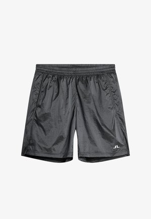 Shorts de course légers, noirs, avec une taille élastique, fabriqués en matériau lisse et réfléchissant. Présente des poches latérales et un logo sur l'ourlet.