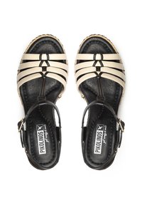 Sandalias de espadrille con tiras en cuero crema y negro, con una plantilla negra texturizada y una suela de yute trenzado. Presentan una correa para el tobillo ajustable.