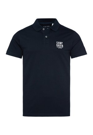 Navy blue polo shirt with short sleeves and a two-button placket. Features a white printed logo on the left chest area. Cotton material.