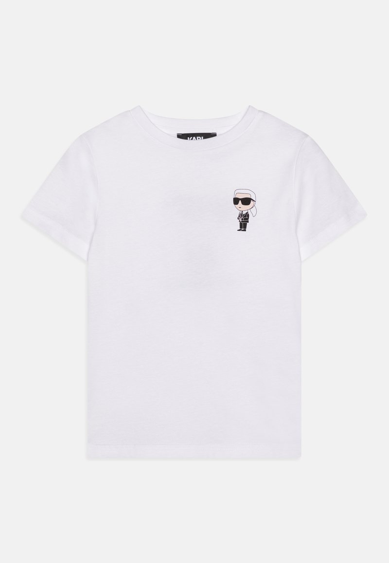 T-shirt bianca in cotone con un piccolo personaggio dei cartoni animati stampato in bianco e nero con occhiali da sole, maniche corte semplici e colletto a girocollo.