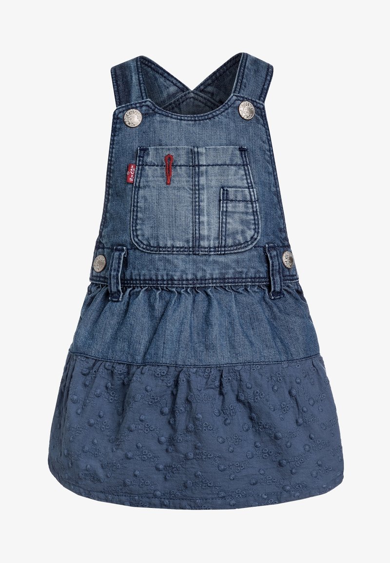 Sukienka ogrodniczka z dżinsu z regulowanymi krzyżującymi się ramiączkami, z przednią kieszenią, rozkloszowanym dołem i teksturowanym niebieskim materiałem z haftowanymi kropkami.