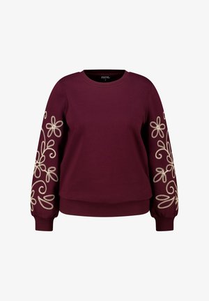 Bordeaux sweatshirt met lange mouwen, voorzien van witte bloemenborduursels op de mouwen. Ronde halslijn en ribgebreide manchetten en onderkant. Zachte stofstructuur.