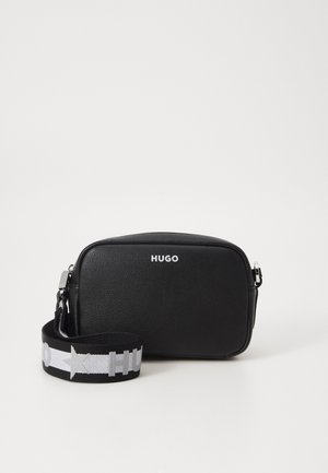 Black leather crossbody bag with a rectangular shape, featuring a silver logo and a contrasting patterned fabric strap.