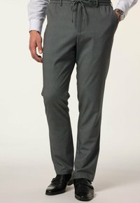 Grau gemusterte Hose mit einem Kordelzugbund, schlanker Schnitt und glatter Textur, kombiniert mit schwarzen Lederschuhen.