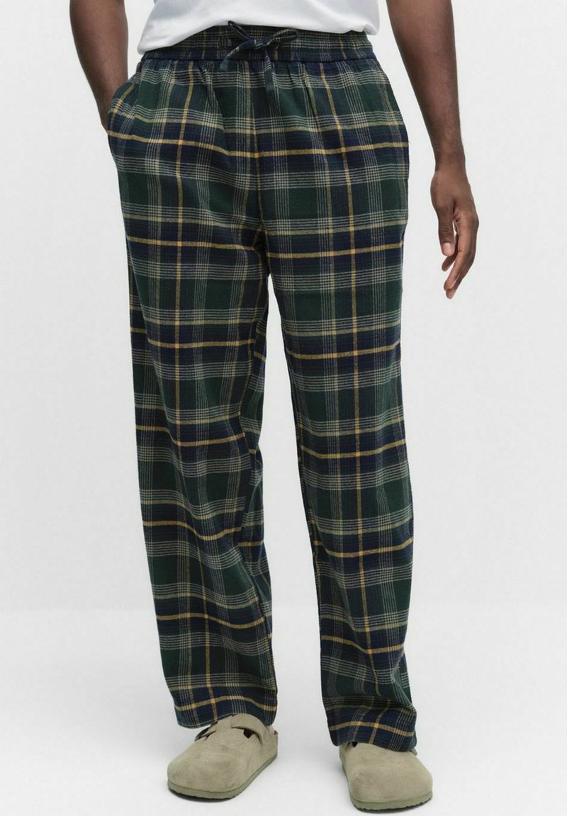 Rutiga pyjamasbyxor med en grön bas och blå och gula linjer, elastisk midja och sidofickor. Mjuk tyg med en avslappnad passform.