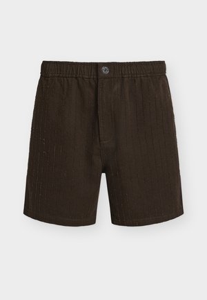Boxers en coton brun foncé avec des lignes verticales cousues, ceinture élastique et fermeture braguette avec un seul bouton.