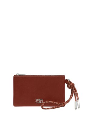 Cartera de cuero roja con cierre de cremallera, que presenta una correa de muñeca trenzada y herrajes en tono plateado. Logo mostrado en la parte frontal.