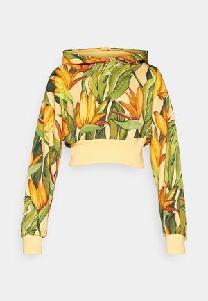 Lühem kraeaga kapuuts, mis on valmistatud lillemustriga kangast, millel on kollased lilled ja rohelised lehed, kollase soonikkraega ja -manšetiga.