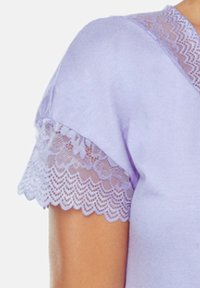 Top lawendowy z krótkimi rękawami, wykończonymi koronki cekinowej, gładką fakturą i klasycznym dekoltem.
