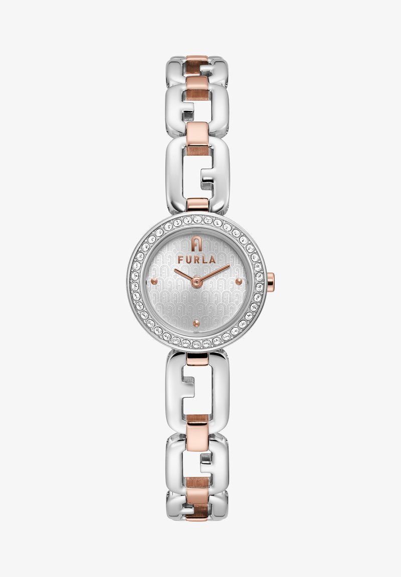 Furla kellaga, millel on hõbedane ringikujuline põhiplaat, roosa kuldne detail ja hõbedaste lingitega randmeosa. Omab kristallidega kaetud raami ja mustritega kellapinda.