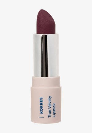 Deep plum-colored Korres True Velvety Lipstick in a light pink tube with silver metallic inner casing.