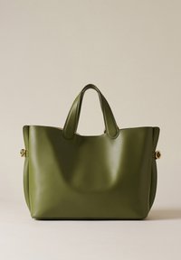 Green leather tote bag with smooth texture, rounded top, and short handles. Features gold-tone hardware on sides for added detail.