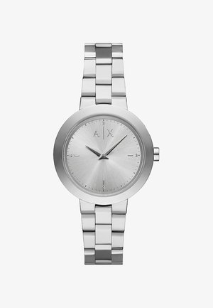 Reloj de acero inoxidable plateado con un dial redondo cepillado en plata, marcadores de hora simples y una pulsera de eslabones pulidos. Cuenta con una corona lateral.