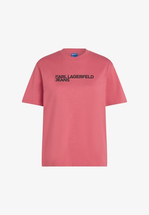 Rozā kokvilnas T-krekls ar apaļu kakla izgriezumu, īsām piedurknēm un uzkrītošu melnu "KARL LAGERFELD JEANS" logo krūtīs.