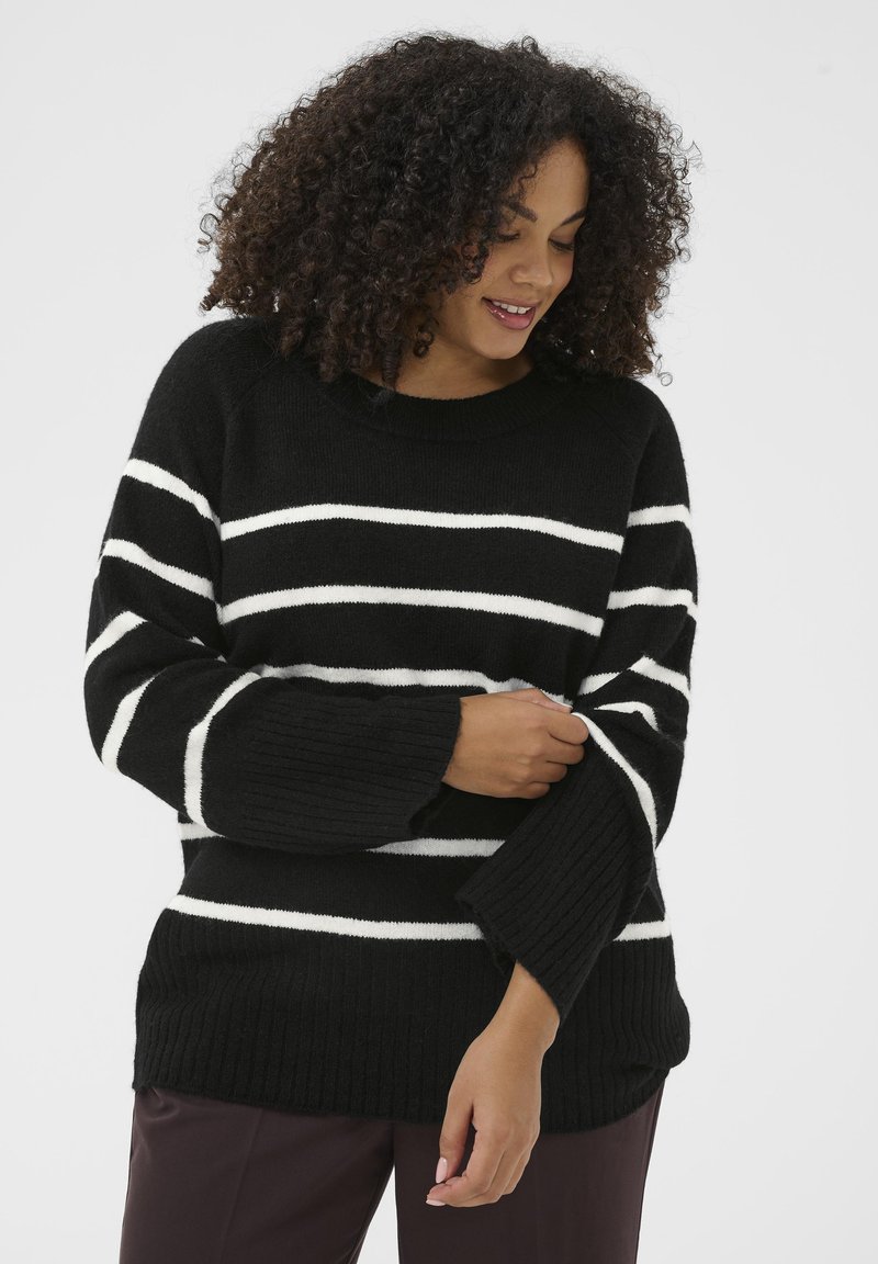 Black and white striped wool sweater with a round neckline, ribbed cuffs, and body, featuring loose fit and soft texture.