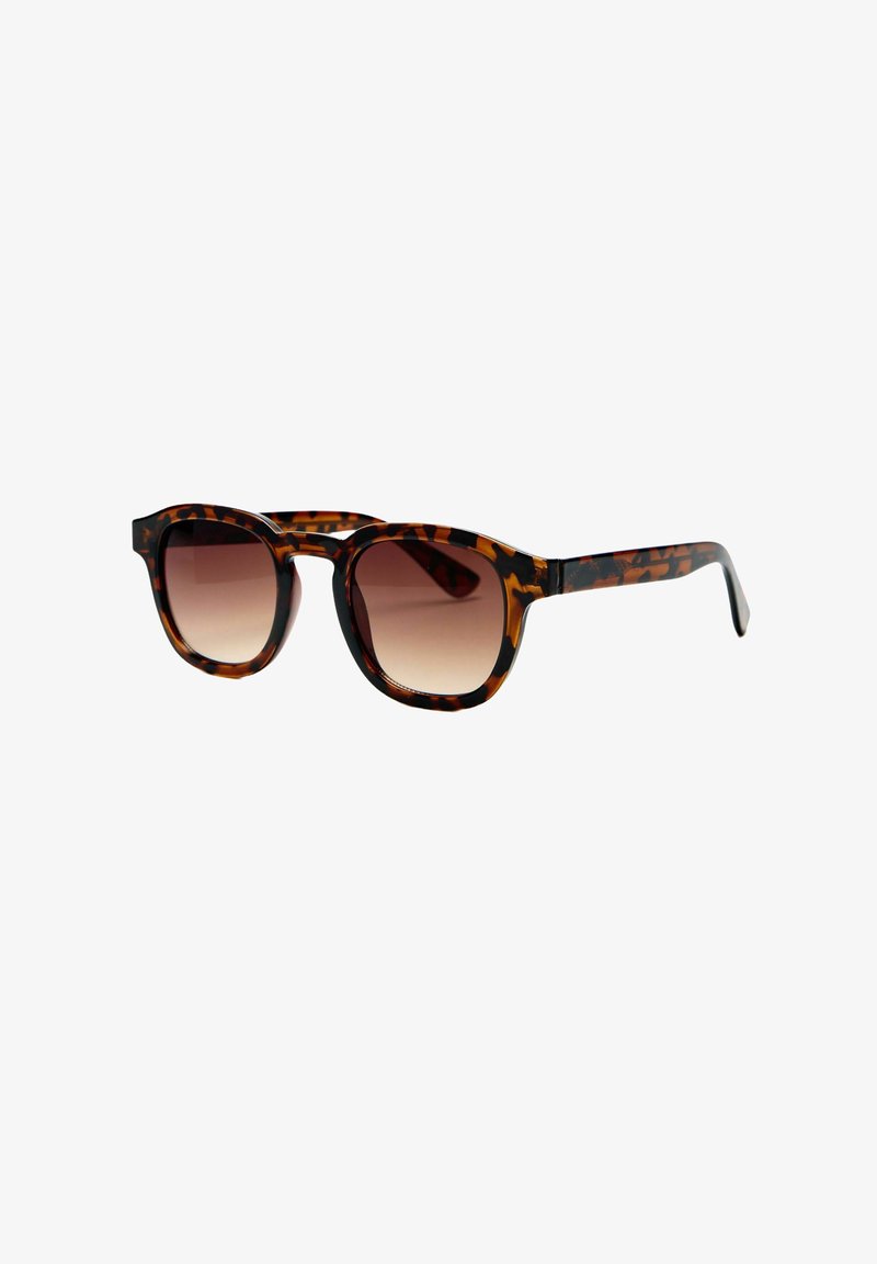 Lunettes de soleil à motif écaille avec verres ronds marron dégradés et une monture élégante.