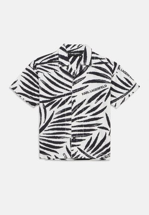 White short-sleeve button-up shirt with black zebra stripes and "KARL LAGERFELD" text printed on the chest and sleeve.