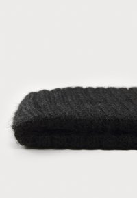 Black knitted wool scarf, featuring a textured rib pattern and soft finish. Folded with visible fibers, providing a cozy appearance.