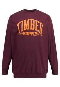 Bordowy długi rękaw sweter wykonany z bawełny. Posiada duży pomarańczowy napis "TIMBER SUPPLY" oraz ściągacze przy rękawach i u dołu.