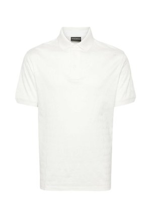 White polo shirt made of cotton, featuring a classic collar, short sleeves, and three buttons at the front. Plain texture without patterns.