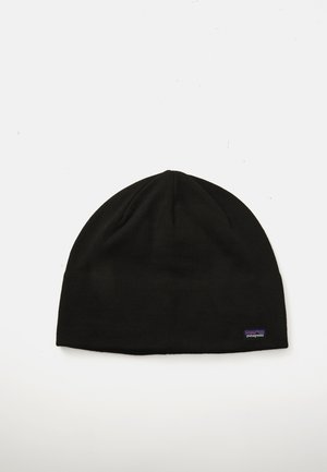 Black knitted beanie featuring a smooth texture and rounded top, with a small purple Patagonia logo stitched on the side.