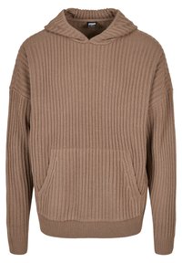 Brun ribbad stickad hoodie med en framficka och huva. Tygets struktur är mjuk och tjock, med en avslappnad passform och vida ärmar.