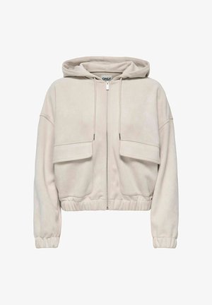 Light beige cropped hoodie with a front zipper, two large flap pockets, ribbed cuffs, and a drawstring hood. Soft, textured fabric.