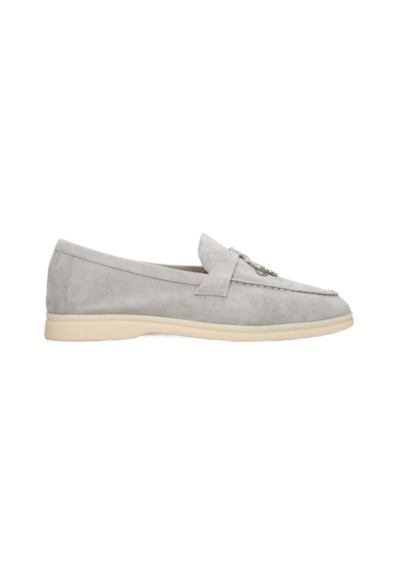 Gray suede loafers with a slip-on design, featuring a decorative strap and stitching detail. Smooth texture and light-colored sole.