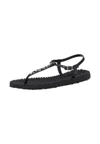 Sandalia negra con suela texturizada trenzada, con un diseño de tira en T y un acento decorativo de flores en blanco y negro en la tira.