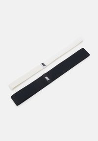 Black and white Nike headbands, made of elastic material, flat design, featuring small Nike logos on fabric. Each band is different in color.