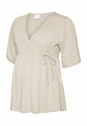 Beež lühikeste varrukatega raseduse t-särk, millel on risti ette seotud esikülg, vöökoha detailiks lips ja rinnapiirkonna all lahtine, kogutud kangas.