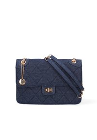 Quilted denim handbag in dark blue with gold-tone hardware, featuring a flap closure and a chain strap. Notable round charm attached.