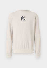 Beige ribbestrikket sweatshirt med et marineblått logo på brystet, rund hals og båndede mansjetter. Glatt tekstur med en avslappet passform.