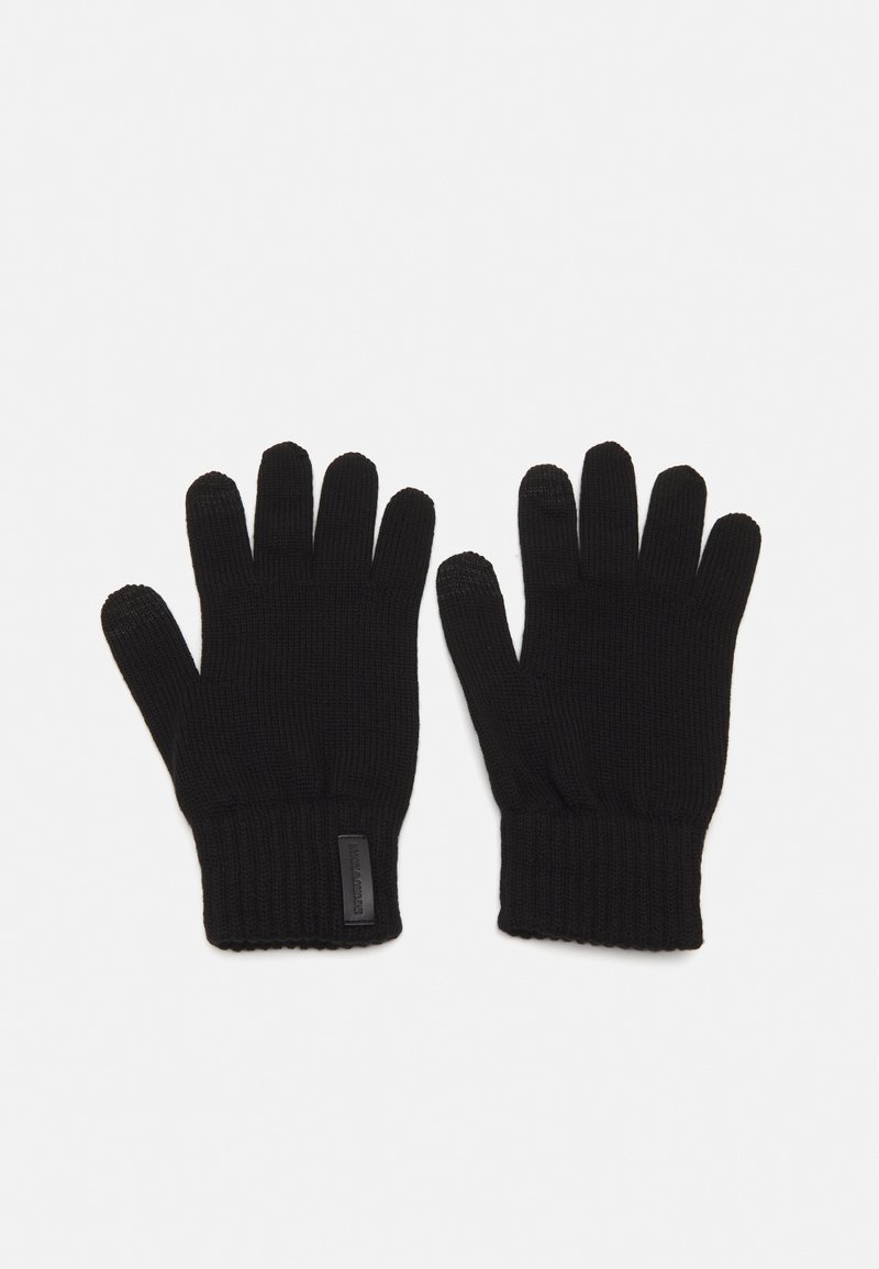 Svarta stickade handskar med ribbad mudd, femfingerdesign och en liten etikett på ena mudden, vilket visar en jämn och strukturerad finish.