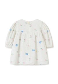 Abito di cotone bianco con ricami floreali in rosa, giallo e blu. Caratterizzato da maniche lunghe a palloncino e una vita arricciata con chiusura posteriore.