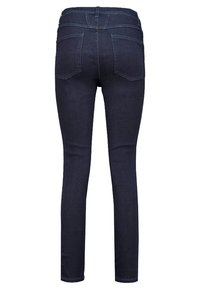 Tmavě modré džínové skinny džíny s hladkým povrchem, zadními kapsami a přiléhavým střihem. Mají středně vysoký pas.