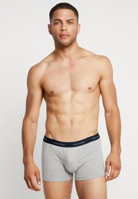 Gray cotton boxer briefs with a navy blue waistband featuring white lettering. The fabric has a smooth texture and a snug fit.