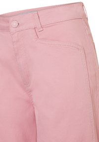 Close-up of pink denim pants showing front pocket, button, belt loops, and detailed stitching.