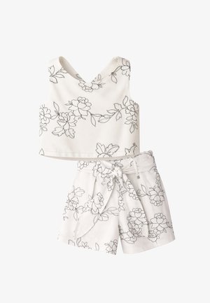 Completo bianco in due pezzi con motivi floreali neri a linee, composto da un top corto senza maniche con scollo a V e pantaloncini a vita alta con fiocco in tessuto.