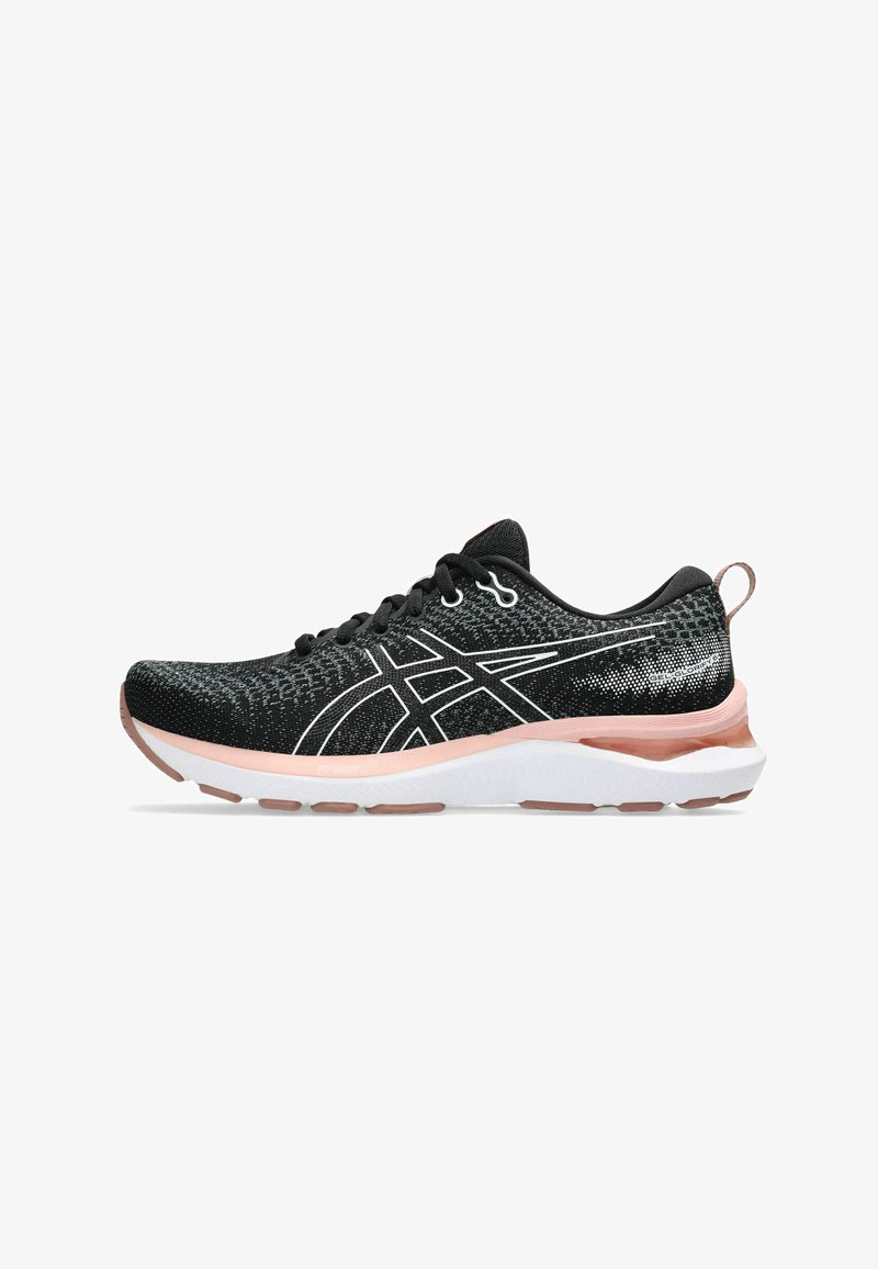 Black athletic shoe with a textured knit upper, white accents, cushioned pink midsole, and black laces. Features a tab at the heel.