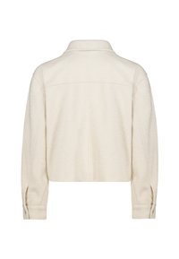 Cropped, cream-colored jacket made of soft fabric, featuring a collar and buttoned cuffs with a textured surface.