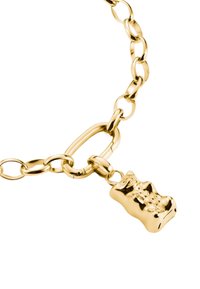Bracelet en chaîne dorée avec des maillons ovales et ronds, mettant en avant un petit charme en forme d'ours en gomme suspendu à un grand maillon ovale.