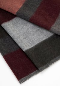 Wool plaid blanket in shades of burgundy, gray, and black; soft texture with frayed edges; rectangular design showcasing color blocks.
