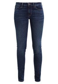 Mörkblå skinny jeans i denim med en slät textur, med femfickorsdesign och diskreta söm detaljer.