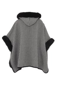 Houndstooth-mønstret poncho med sort faux fur-kant, der har hætte og vide ærmer, i en sort-hvid farveskala.